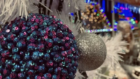 Sequin Ball Christmas Ornament With Blurry Motion LED Lights On The Background. Video stock 121009341