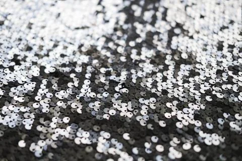 Sequin fabric texture. Shiny silver sparkling background. Clothing piece of Stock Photos