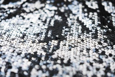 Sequin fabric texture. Shiny silver sparkling background. Clothing piece of Stock Photos