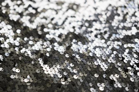 Sequin fabric texture. Shiny silver sparkling background. Clothing piece of Stock Photos