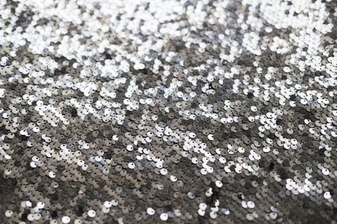 Sequin fabric texture. Shiny silver sparkling background. Clothing piece of Stock Photos