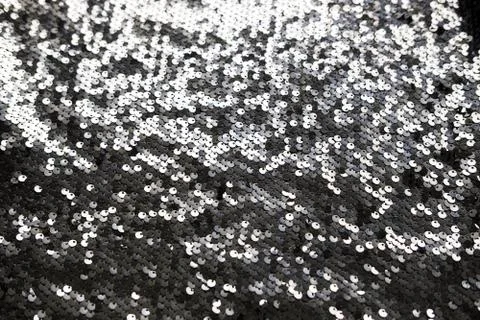 Sequin fabric texture. Shiny silver sparkling background. Clothing piece of Stock Photos