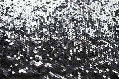 Sequin fabric texture. Shiny silver sparkling background. Clothing piece of Stock Photos