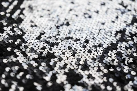 Sequin fabric texture. Shiny silver sparkling background. Clothing piece of Foto stock