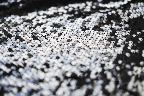 Sequin fabric texture. Shiny silver sparkling background. Clothing piece of Stock Photos