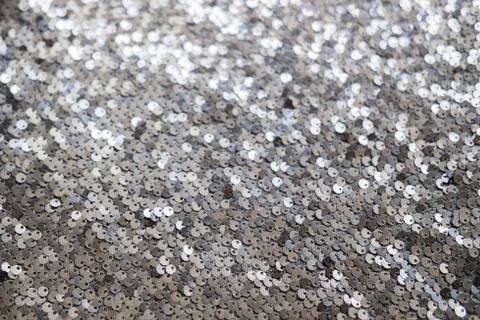 Sequin fabric texture. Shiny silver sparkling background. Clothing piece of Stock Photos