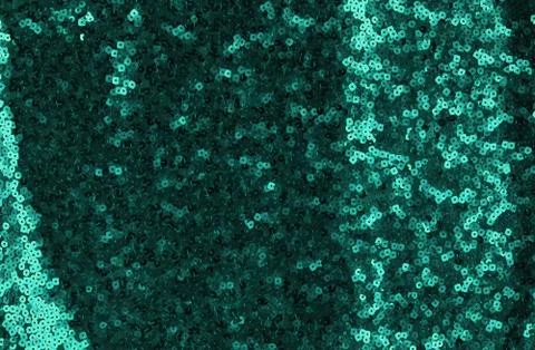 Sequin texture background. Green color fabric.  Christmas, festive background Stock Photos
