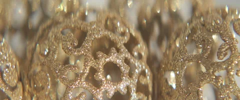 Sequined bauble on white slow sliding 5.7K scope video Stock Footage 316364779
