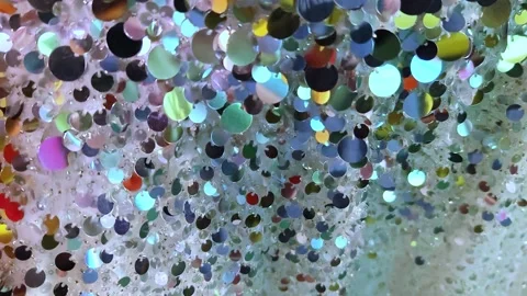 Sequins close-up. Abstract background with sequins colorful on the fabric. Stock Footage 297825699