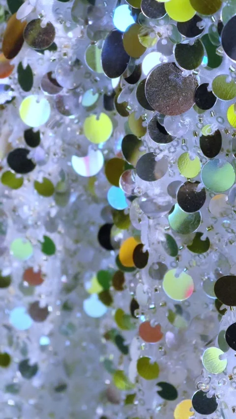 Sequins close-up. Abstract background with sequins colorful on the fabric. 動画素材 297866005