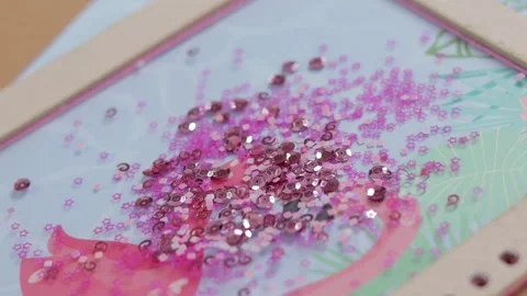 Sequins in different shapes falling on a large glittering pile, close up Stock Footage 285541046