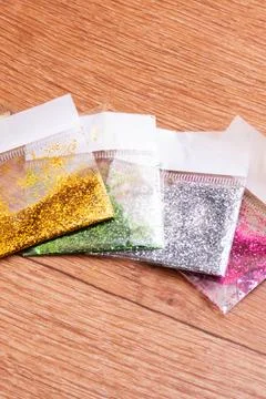 Sequins for needlework in bags on the table Stock Photos