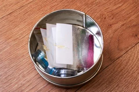 Sequins for needlework in bags on the table Stock Photos
