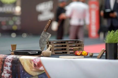 Serbian chef knife on a table alongside chilli peppers and herbs waiting fo.. Stock Photos