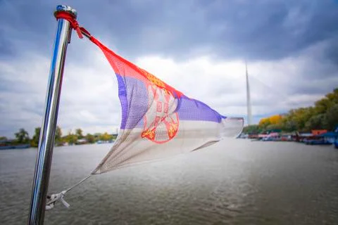 Serbian flag above river Stock Photos