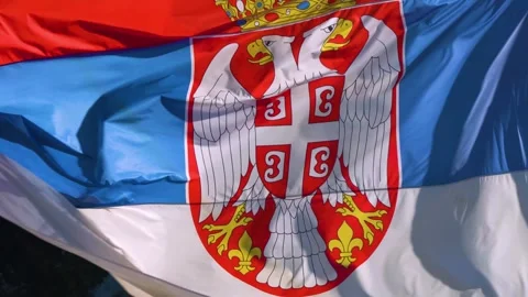The Serbian flag is flutters (waving) in the wind. Stock Footage 248801317