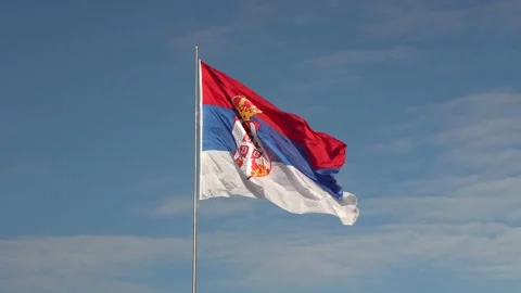 Serbian flag waving in the wind on clear day Stock Footage 318657053