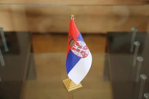 Serbian Table Flag on Glass Surface: National Symbol Display Stock Photos