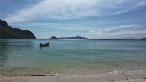 Serene 180-degree panoramic left to right from tree-lined shore to calm sea Stock Footage 326243339