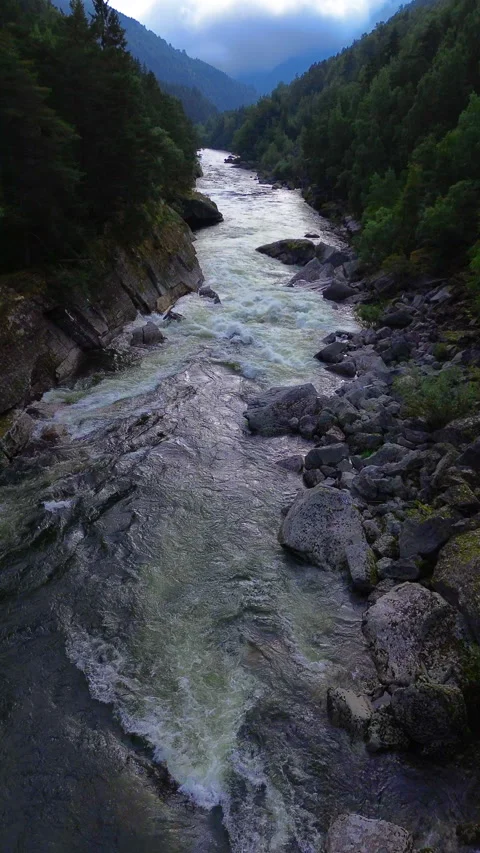 Serene 4K Mountain River Flowing Through Lush Green Landscape in Norway Stock Footage 296019190