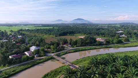 Serene aerial shot capturing a tranquil countryside landscape: emerald Stock-Footage 339848833