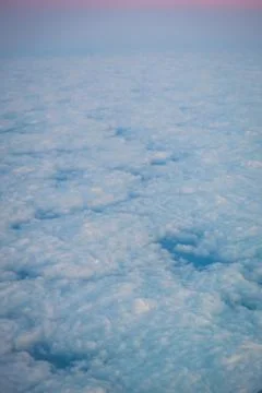 Serene Aerial View of a Layer of Clouds Beneath a Pastel Sky Stock Photos