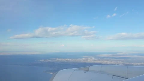 Serene Airplane Window View with Wing and Clouds | 4K Stock Footage 298147289