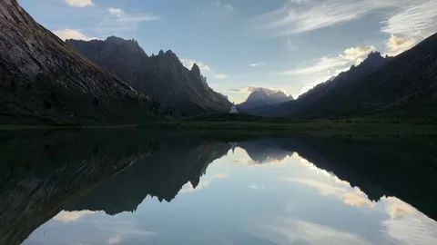 Serene Alpine Lake Mirroring Dramatic Mountains and Stupa China Stock Footage 339663953