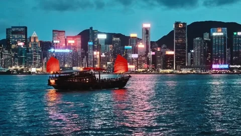 A serene and dynamic nighttime view of Hong Kong's iconic skyline and vibrant Stock Footage 338280347