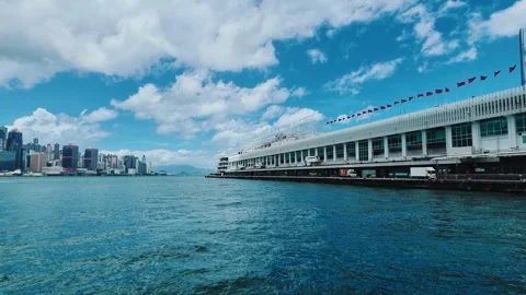 A serene and dynamic scene showcasing a modern waterfront terminal in Hong Kong Video stock 338310972