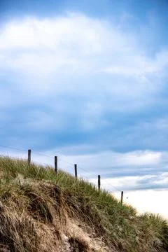 A serene and evocative landscape capturing the natural beauty of a coastal sa Stock Photos