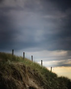 A serene and evocative landscape capturing the natural beauty of a coastal sa Stock Photos