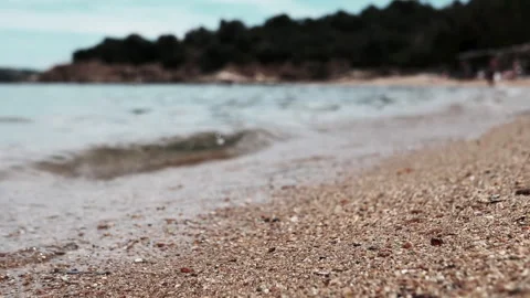 A serene and tranquil beach scene featuring gentle waves rolling onto a Stock Footage 313873056