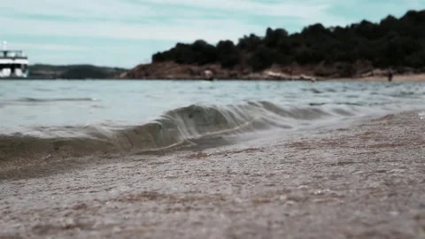 The Serene and Tranquil Beach With Waves Gently Rolling Beneath a Calm and Clear Stock Footage 313873251
