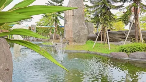 Serene and Tranquil Scene of a Small Water Fountain in A Pond at the Park Stock Footage 286082305