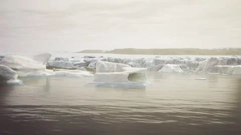 Serene Antarctic scene with floating ice and still reflecting surface Stock Footage 341579795