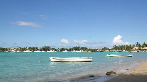 Serene bay in Mauritius featuring small fishing boats gently floating on Video stock 318087377