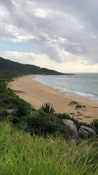 Serene beach on a cloudy day Stock Photos