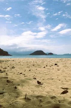 Serene Beach with Distant Islands Stock Photos