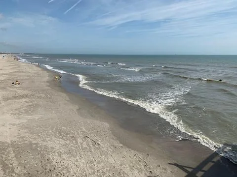 Serene beach with gentle waves Stock Photos