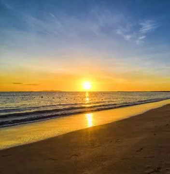 A serene beach landscape at sunset Stock Photos