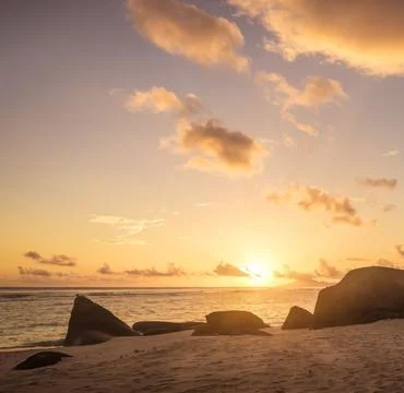 A serene beach landscape at sunset Stock Photos