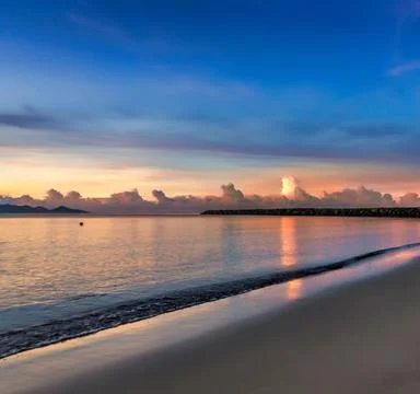 A serene beach landscape at sunset Stock Photos