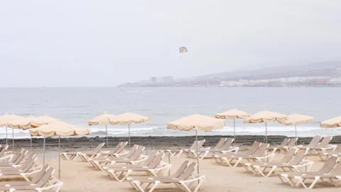 Serene Beach Scene with Parasailing on a Cloudy Day Stock Footage 315769678