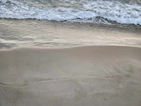 Serene beach setting, Tranquil beach environment featuring smooth ripples and Stock Photos