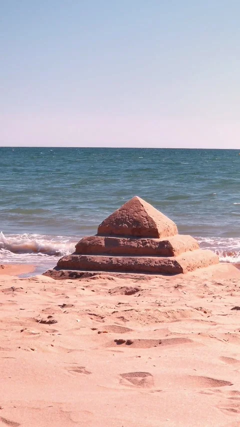 Serene Beach with Standout Sand Pyramid Structure Stock Footage 284433120