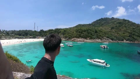 Serene Beach View with Clear Waters and Lush Green Hills Stock Footage 314637756