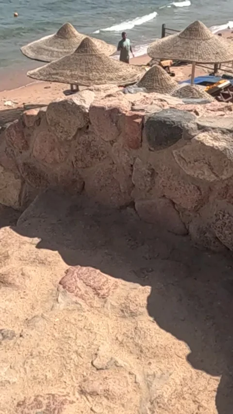 Serene Beach View Featuring Stacked Stone Pathway Leading to Sun-Chaise Lounge Stock Footage 330065711