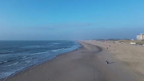 Serene Beach View Under Clear Blue Sky, North Sea, Winter, Netherlands Vídeos de archivo 295937965
