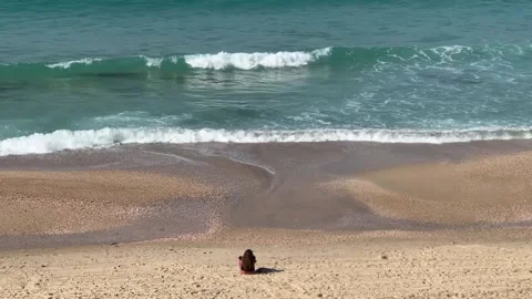 A serene beach with waves chasing each other toward the shore Stock Footage 294723064